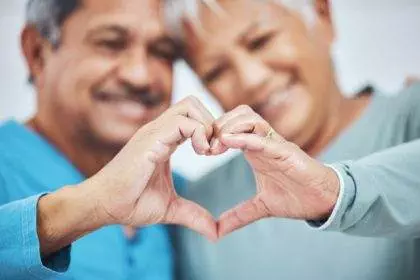 Heart, mature couple and hands for care in healthy relationship, connection or commitment to marria