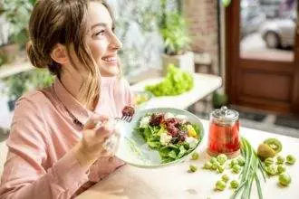 Woman eating healthy green food